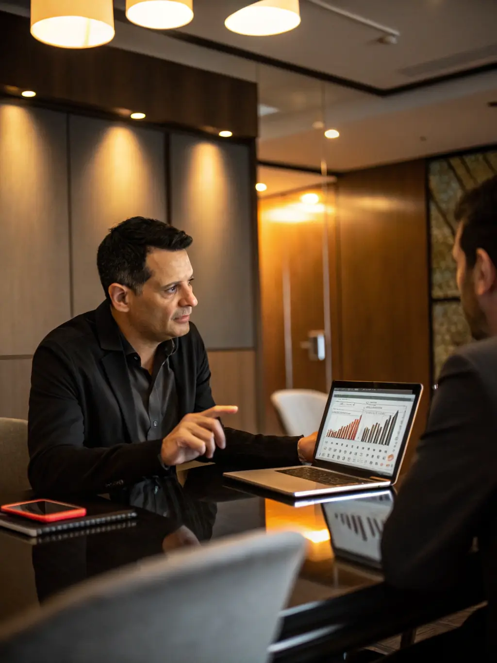 A professional photo of a consultant in a modern office, advising a client on technology strategy, with the Techwings Limited logo subtly displayed in the background.