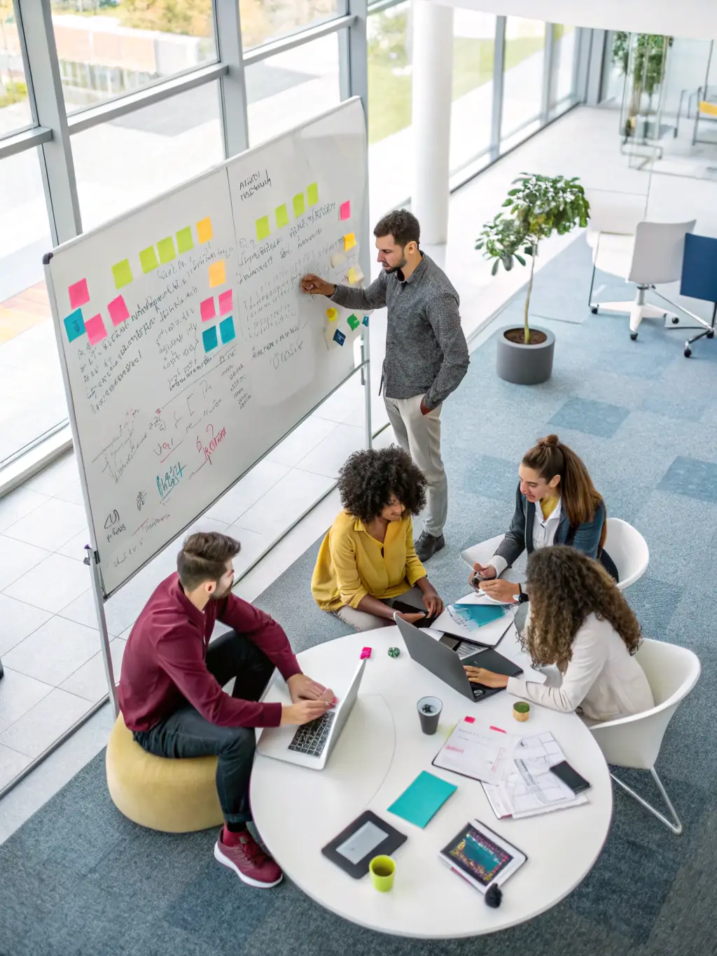 A diverse team brainstorming innovative solutions in a bright, modern office, with the Techwings Limited logo subtly displayed.